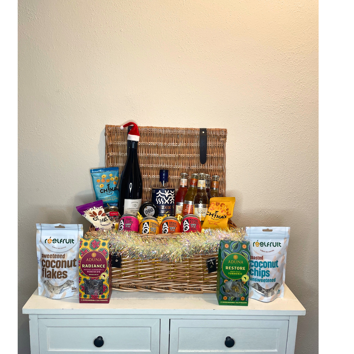 An African themed hamper which includes various African goods, with tinsel and a Christmas hat